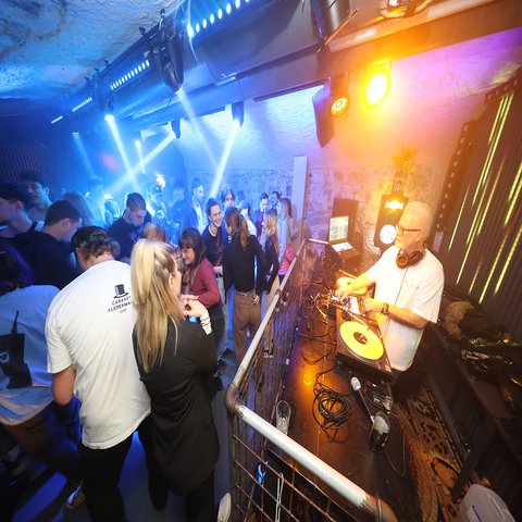 Ein DJ und viele tanzende Menschen